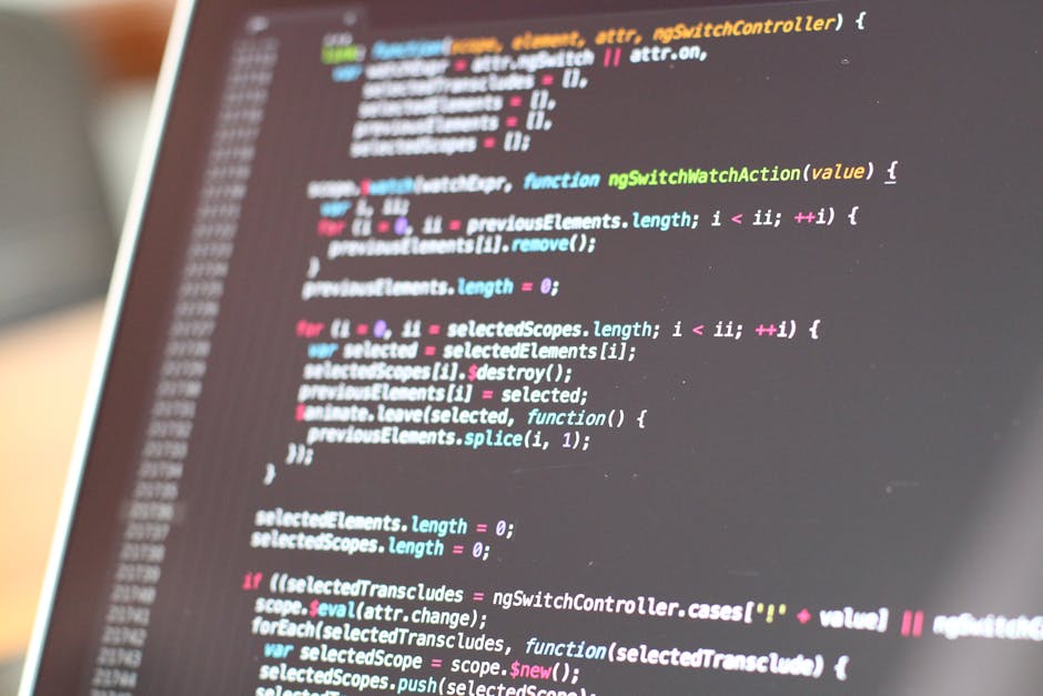 The image shows a close-up of a computer screen displaying a code editor with syntax-highlighted JavaScript code. Visible elements include lines of code with functions, variables, and comments in vari